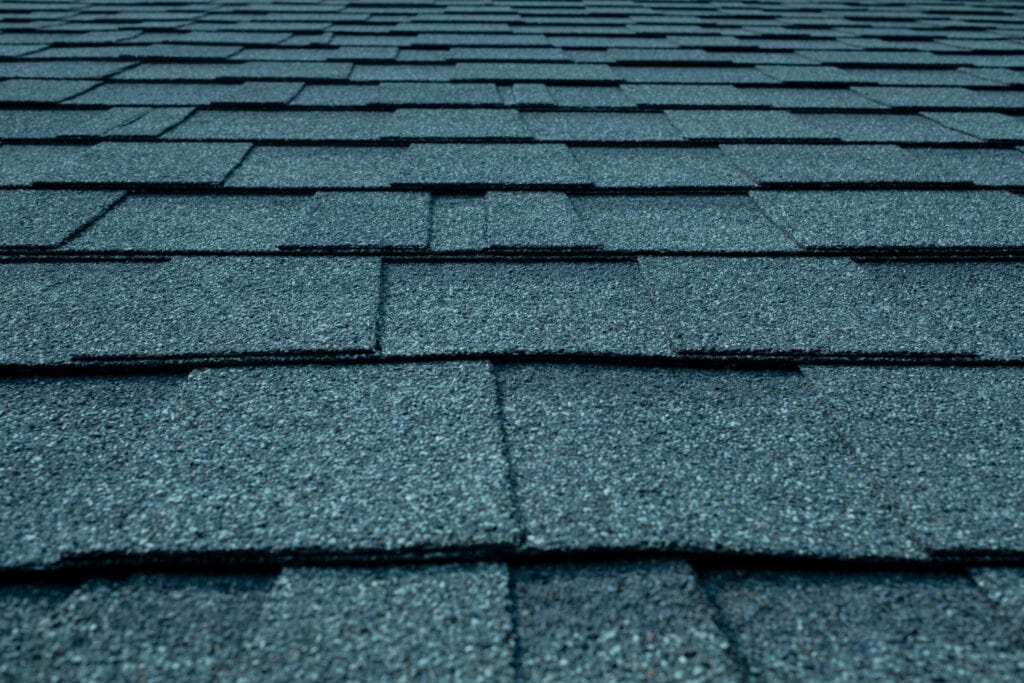 Close-up of asphalt roof shingles, durable roofing materials for residential or commercial roofing services.